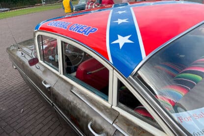 General Cheap antique car with flag like General Lee.