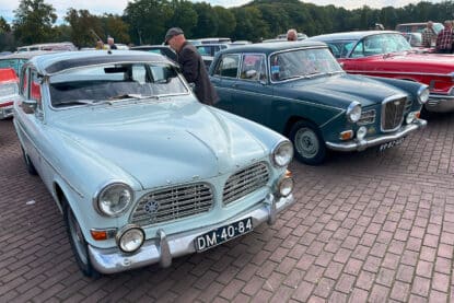 Volvo Amazon 120 and Wolseley 16 60 on a brick parking lot.