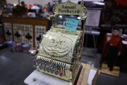 Antique brass, nickel, and copper cash register with ornate engraving and amount purchased display, priced at $700.