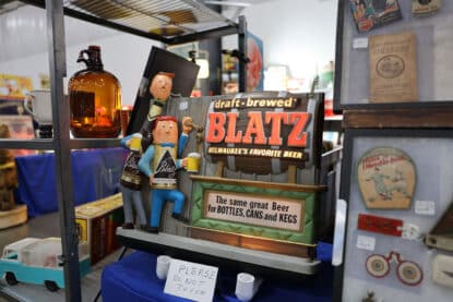 Vintage Blatz Beer animated light-up bar sign with cartoon bartenders and slogan for bottles, cans, and kegs, displayed at the Chicagoland Coin-Op Show.