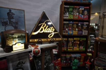 Triangular Blatz Beer sign and Hamm’s display light surrounded by vintage Wacky Wobbler bobbleheads of cereal mascots and TV icons at the Chicagoland Coin-Op Show.