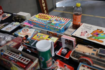 Vintage Bozo the Clown board games, Deputy Dawg cartoon kit, and other retro children's memorabilia on display at the Chicagoland Coin-Op Show.