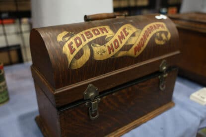 Antique Edison Home Phonograph with original oak carrying case and decorative banner graphic on lid.