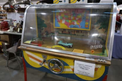 Fully restored Genco Motorama vintage arcade driving game with a miniature turquoise car, U.S. map backdrop, and colorful cabinet design.