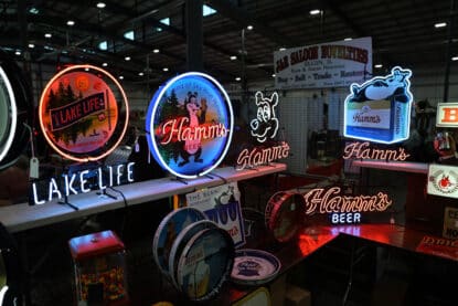 Colorful neon signs for Hamm’s Beer and Lake Life, featuring the Hamm’s bear mascot, on display at the Chicagoland Coin-Op Show.