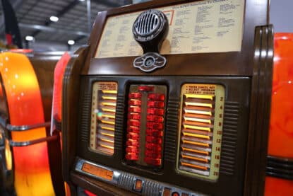 Close-up of illuminated title strip and selection lights on a Rock-Ola Mystic Music jukebox.