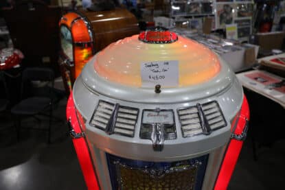 Close-up of Seeburg 148 Trashcan jukebox dome and selection panel with glowing red pilasters and $4500 price tag.