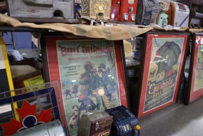 Framed vintage Bull Durham Smoking Tobacco advertisements displayed at antique show.