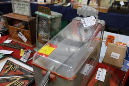 Vintage coin-operated machines on display, including a 1940 Buffalo Token Target game, a Little Whirlwind coin fan machine, and a 7Up-themed spinner game.